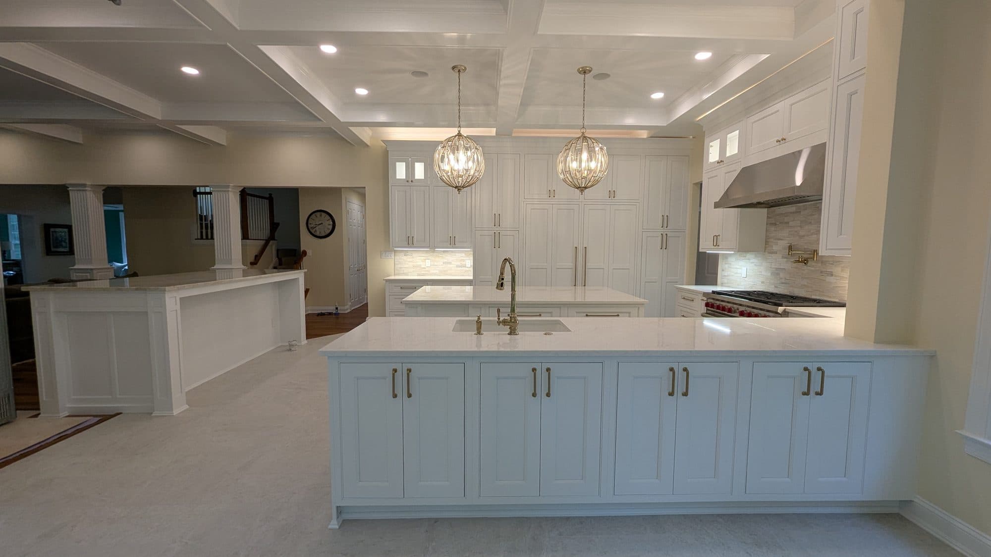 Kitchen island with waterfall marble countertop and connected breakfast nook