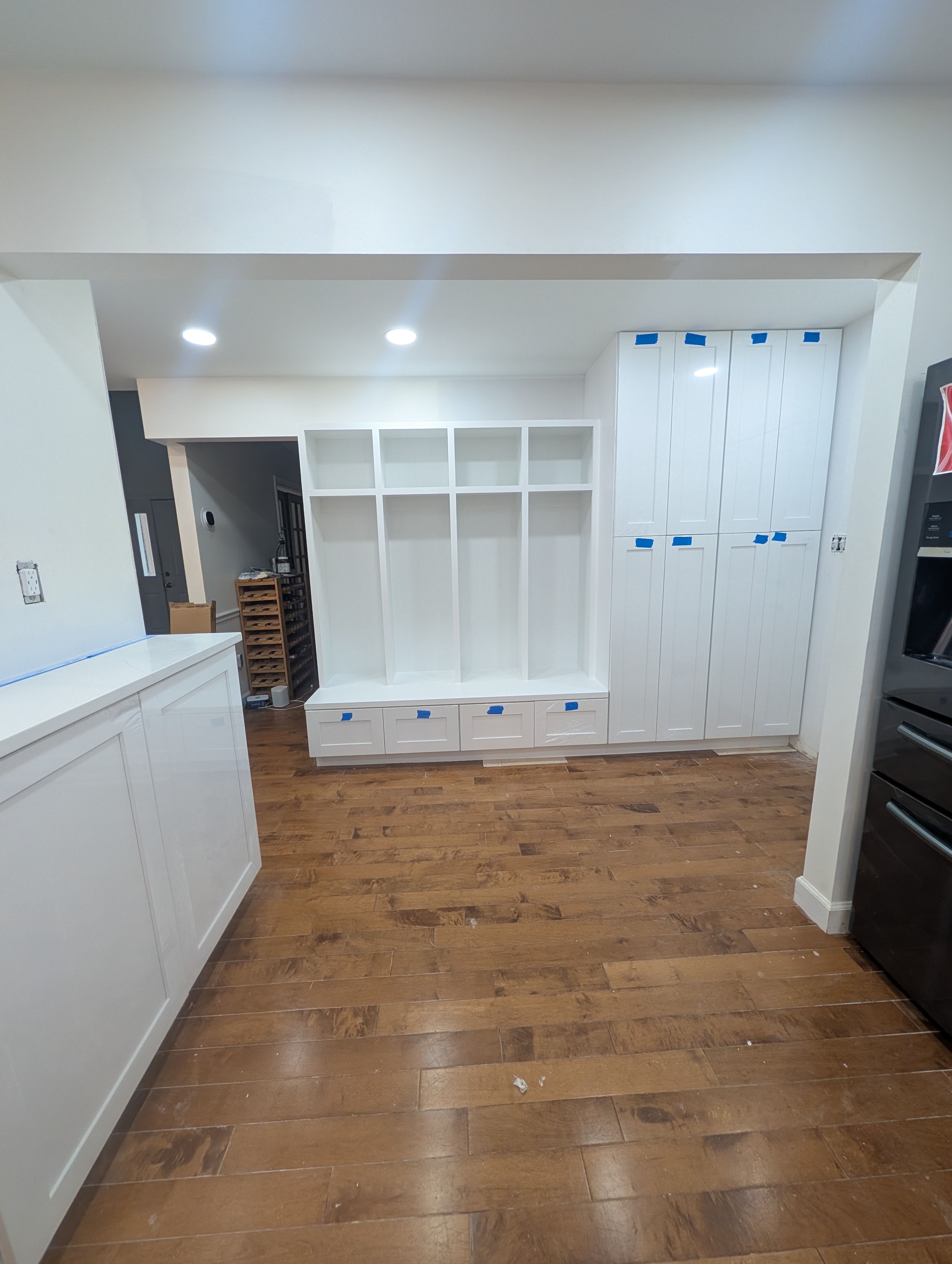 New Herndon kitchen in progress (second project), wide view with a black french-door refrigerator and stacked wall ovens